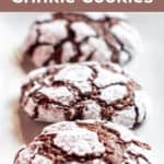three chocolate crinkle cookies on a plate