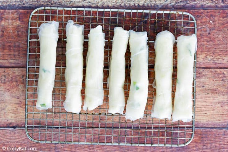 mashed potato spring rolls on a baking rack