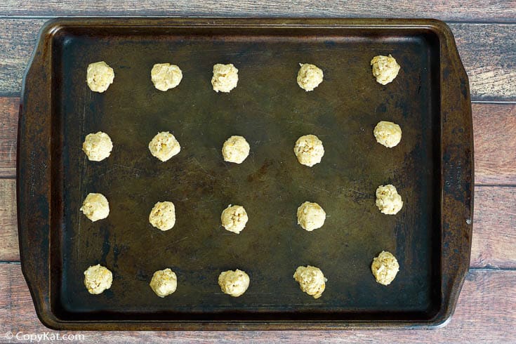 oatmeal coconut crunchies cookie dough balls on a baking sheet