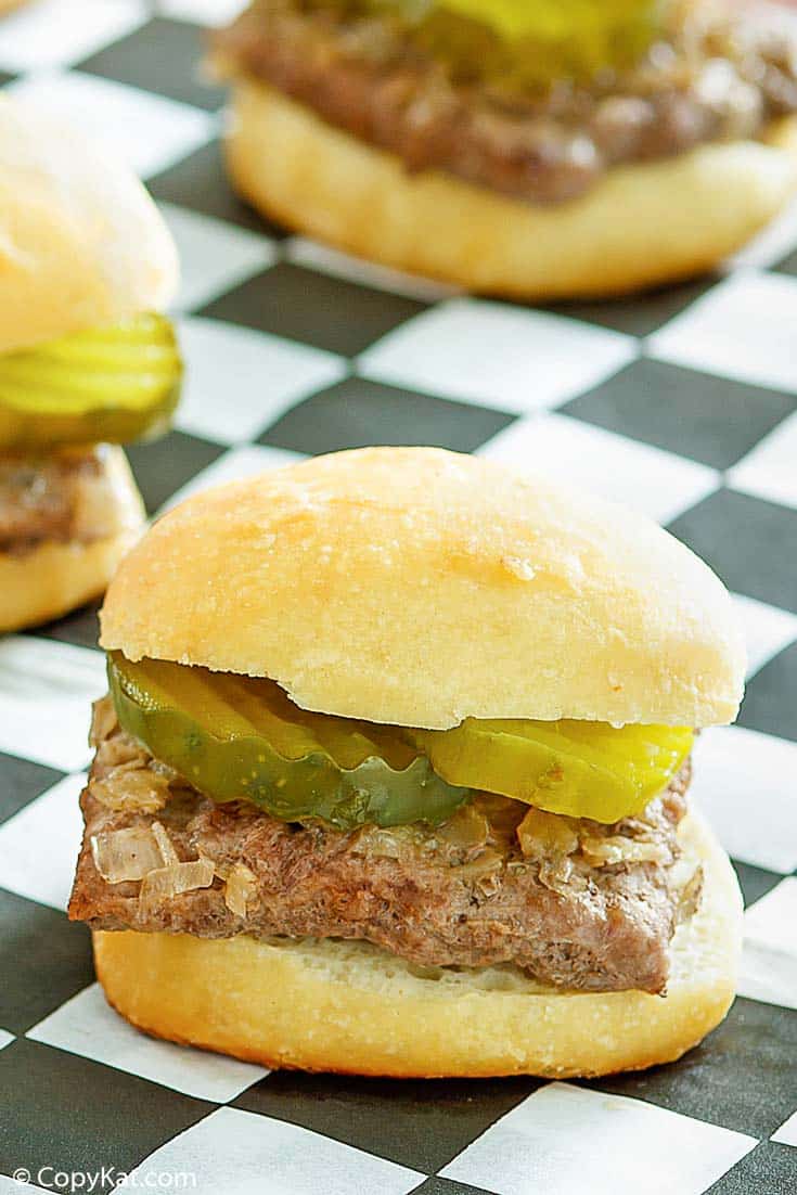 a homemade White Castle hamburger on black and white checked parchment paper