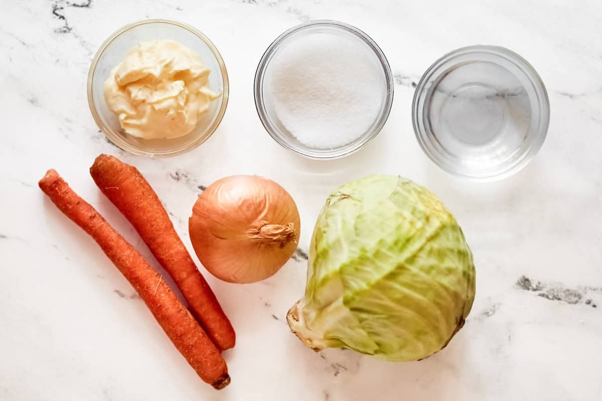 Cabbage, carrots, onion, mayonnaise, oil, sugar, and vinegar.