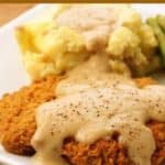 beer battered chicken fried steak with gravy and mashed potatoes