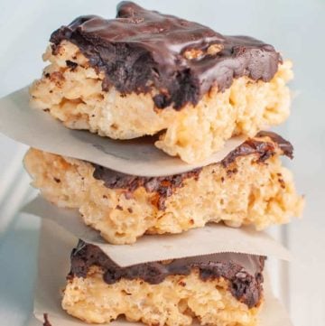 a stack of chocolate ganache covered peanut butter rice krispie treats