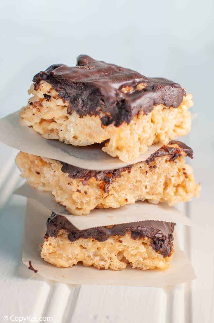 a stack of chocolate ganache covered peanut butter rice krispie treats