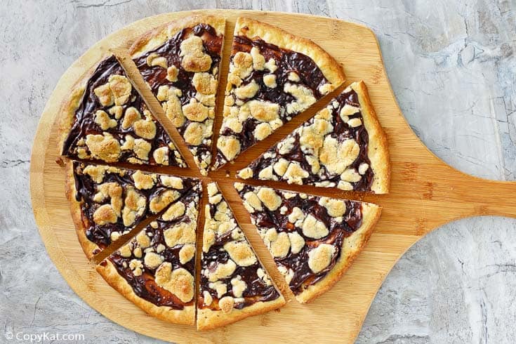 sliced chocolate dessert pizza on a pizza peel