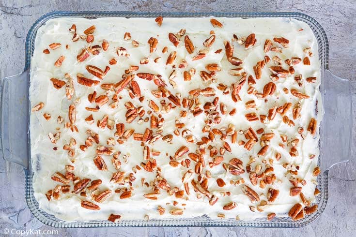 carrot cake with cream cheese frosting in a glass baking dish