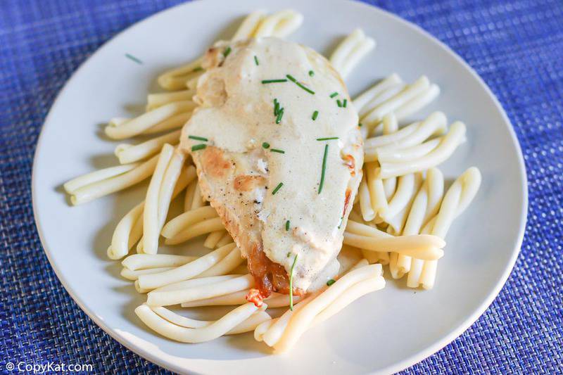 chicken with dijon mustard sauce over pasta on a plate