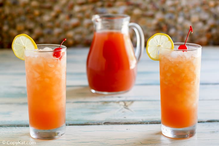 secret passion punch in two glasses and a pitcher