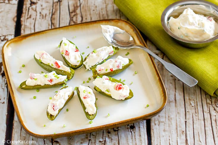 a plate of cream cheese filled fresh jalapeno peppers