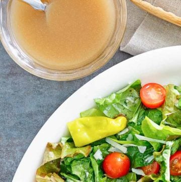 homemade Luigetta's salad dressing next to a salad