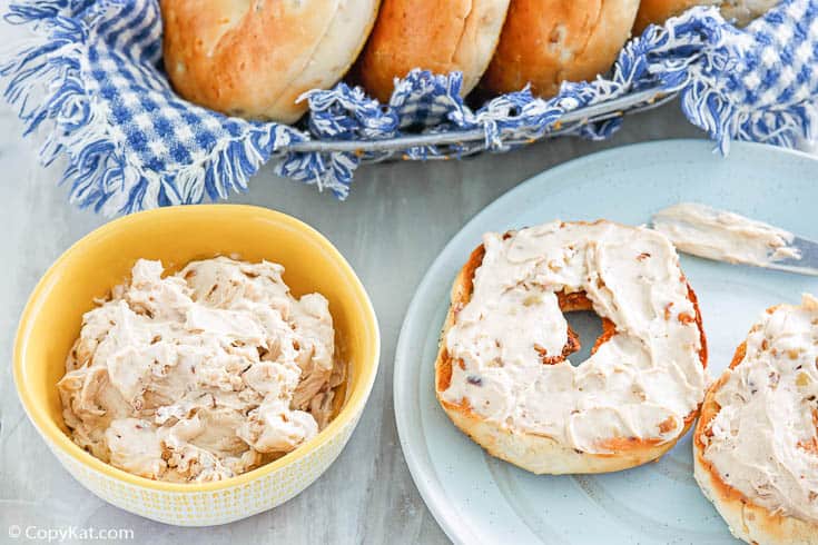homemade Panera honey walnut cream cheese in a bowl and spread on a bagel