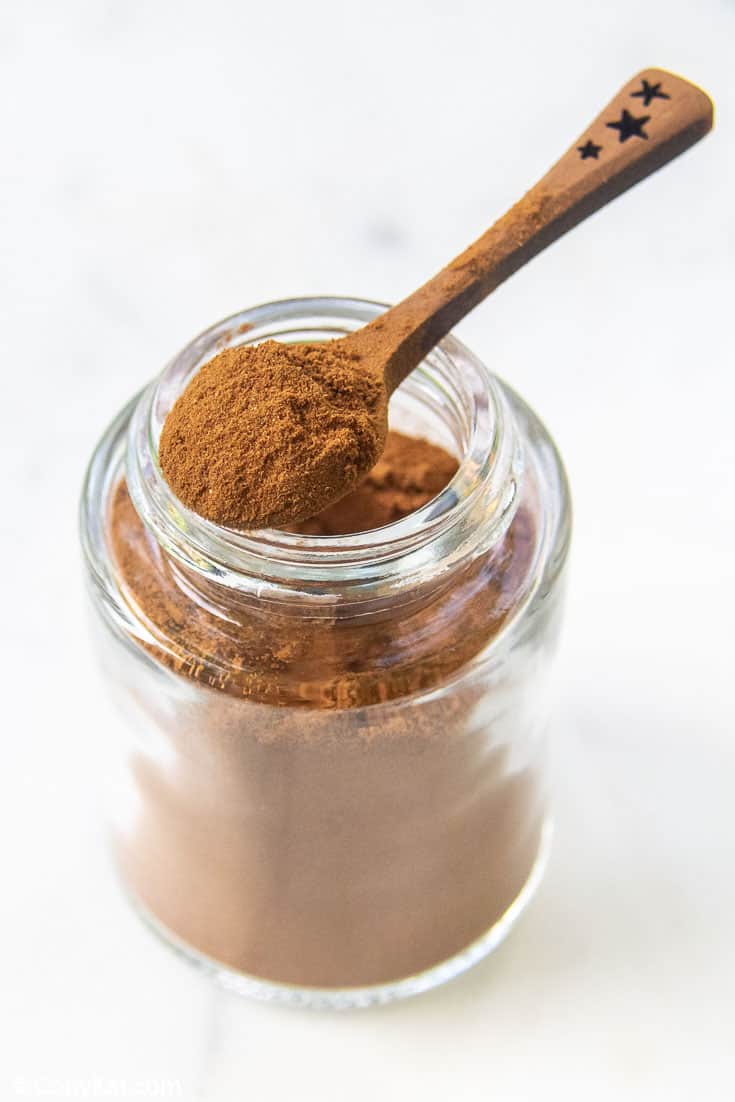 homemade pumpkin pie spice mix in a small spoon on top of a spice jar
