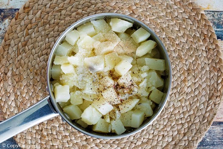 boiled potatoes and seasonings in a sauce pan