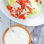 overhead view of blue cheese dressing and wedge salad