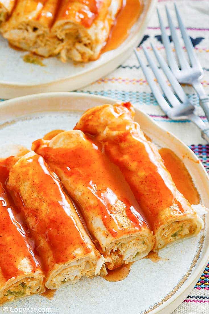 cream cheese yellow enchiladas with sauce on a plate