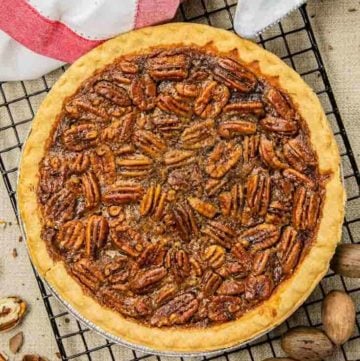 a whole pecan pie on a wire cooling rack