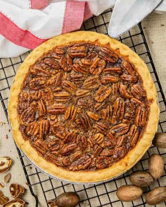 a whole pecan pie on a wire cooling rack
