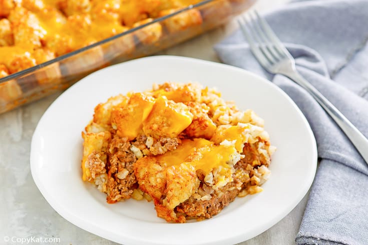 hamburger tater tot casserole on a plate next to a fork