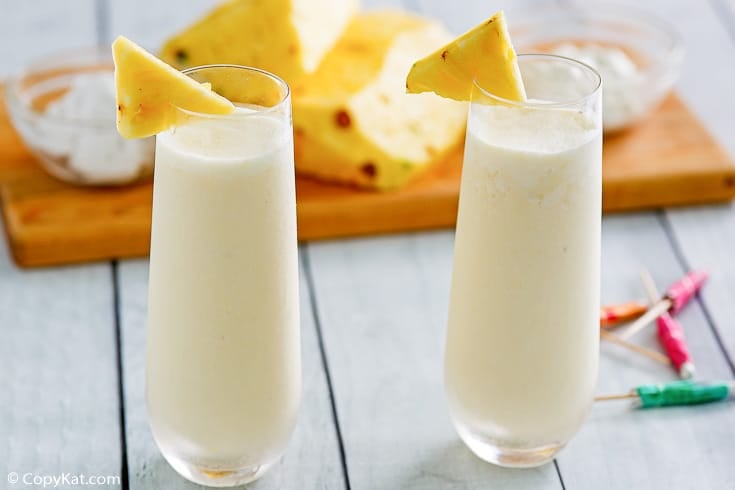 two pina colada smoothie drinks with pineapple