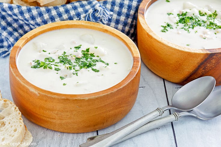 two bowls of clam chowder and two spoons