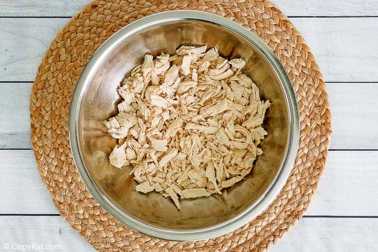 shredded cooked chicken in a mixing bowl