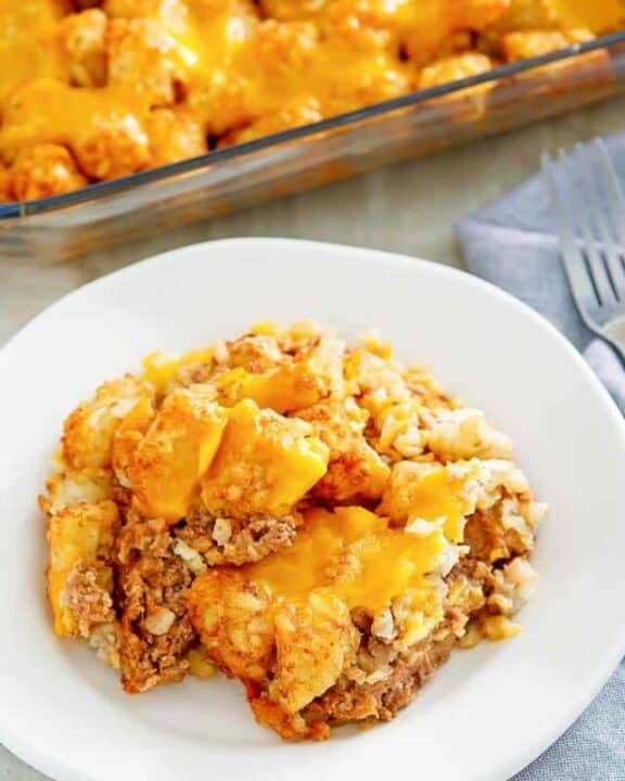 hamburger tater tot casserole in a baking dish and on a plate