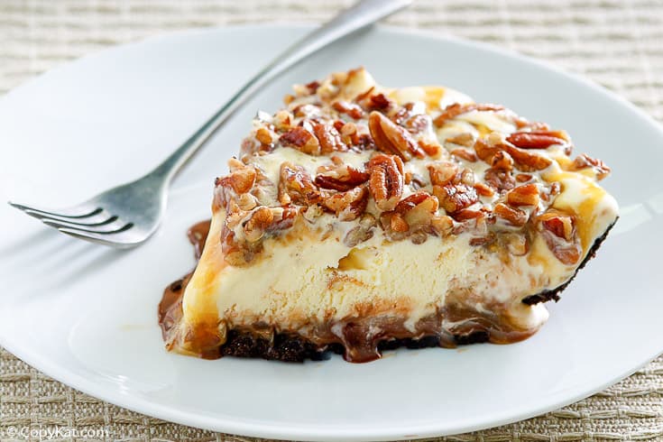 a slice of turtle ice cream pie and a fork on a white plate