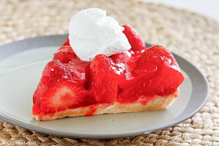 a slice of homemade Big Boy strawberry pie with a dollop of whipped cream on top