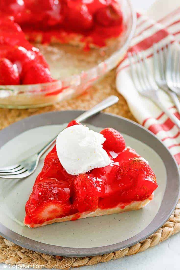 a slice of homemade Big Boy strawberry pie with a dollop of whipped cream on top