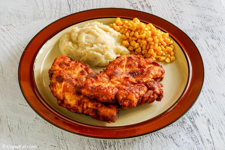 homemade Cracker Barrel homestyle fried chicken, mashed potatoes, and corn on a plate