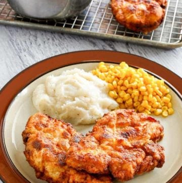 homestyle fried chicken, mashed potatoes, and corn on a plate