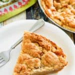 a slice of Dutch apple pie and a fork on a plate