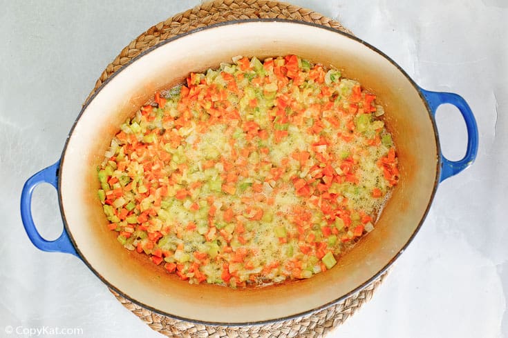 chopped onions, carrots, and celery base for Canadian cheese soup in a Dutch oven