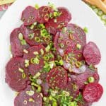 overhead view of marinated beet salad on a platter