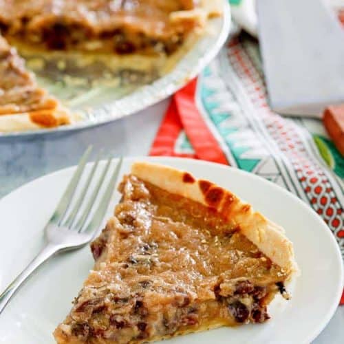 a slice of sour cream raisin pie on a plate next to the pie