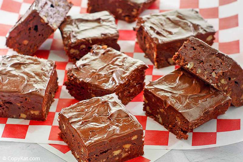 chocolate brownies with frosting on parchment paper