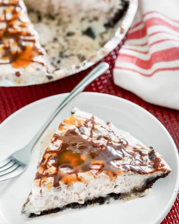 a slice of ice cream pie with toffee and chocolate chips and Oreo crust