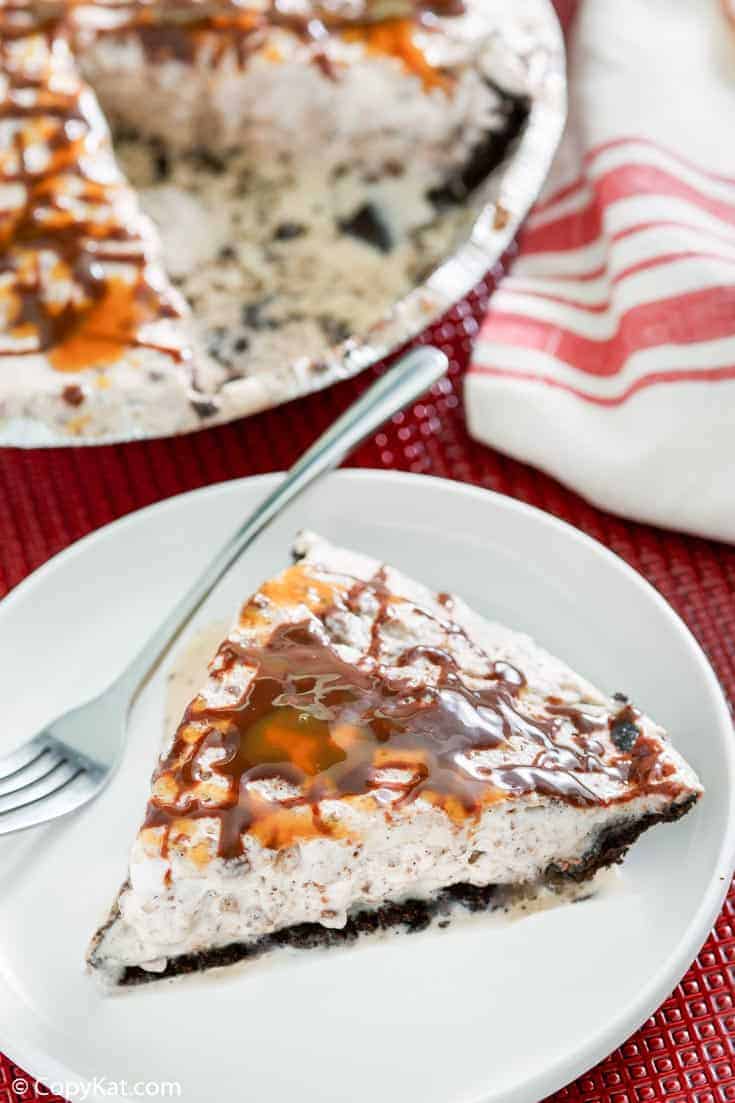 a slice of ice cream pie with toffee and chocolate chips and Oreo crust