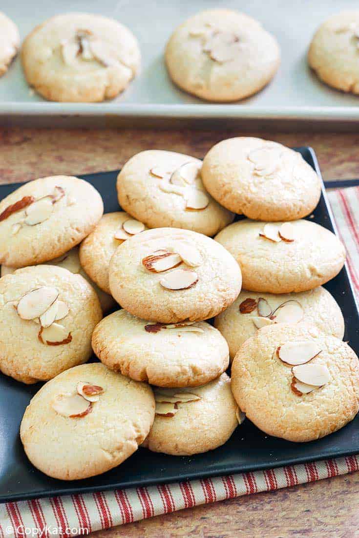 Chinese almond cookies on a platter and baking sheet