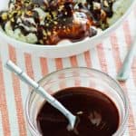 homemade Hershey's chocolate syrup next a bowl of ice cream