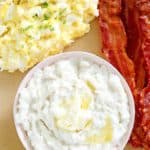 overhead view of eggs, bacon, and grits on a plate