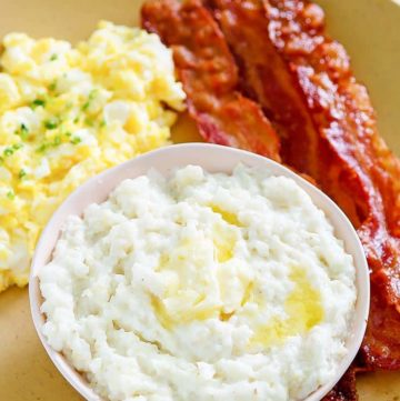 bacon, eggs, and grits on a plate