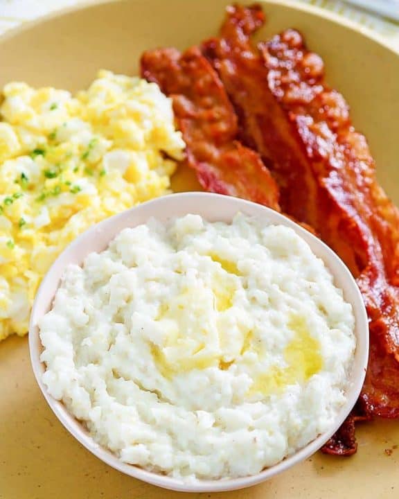 bacon, eggs, and grits on a plate