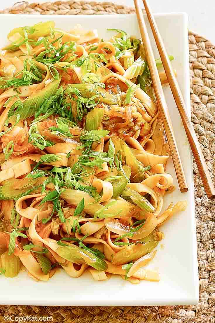 chow mein and chopsticks on a platter