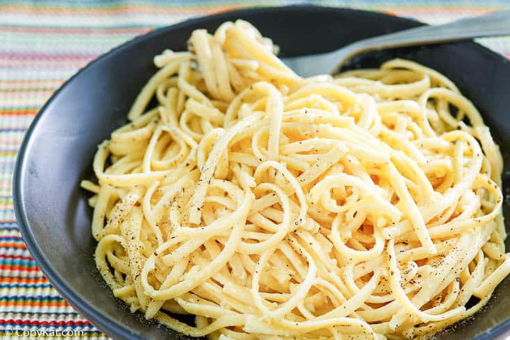 pasta with egg and cheese and a fork in a bowl