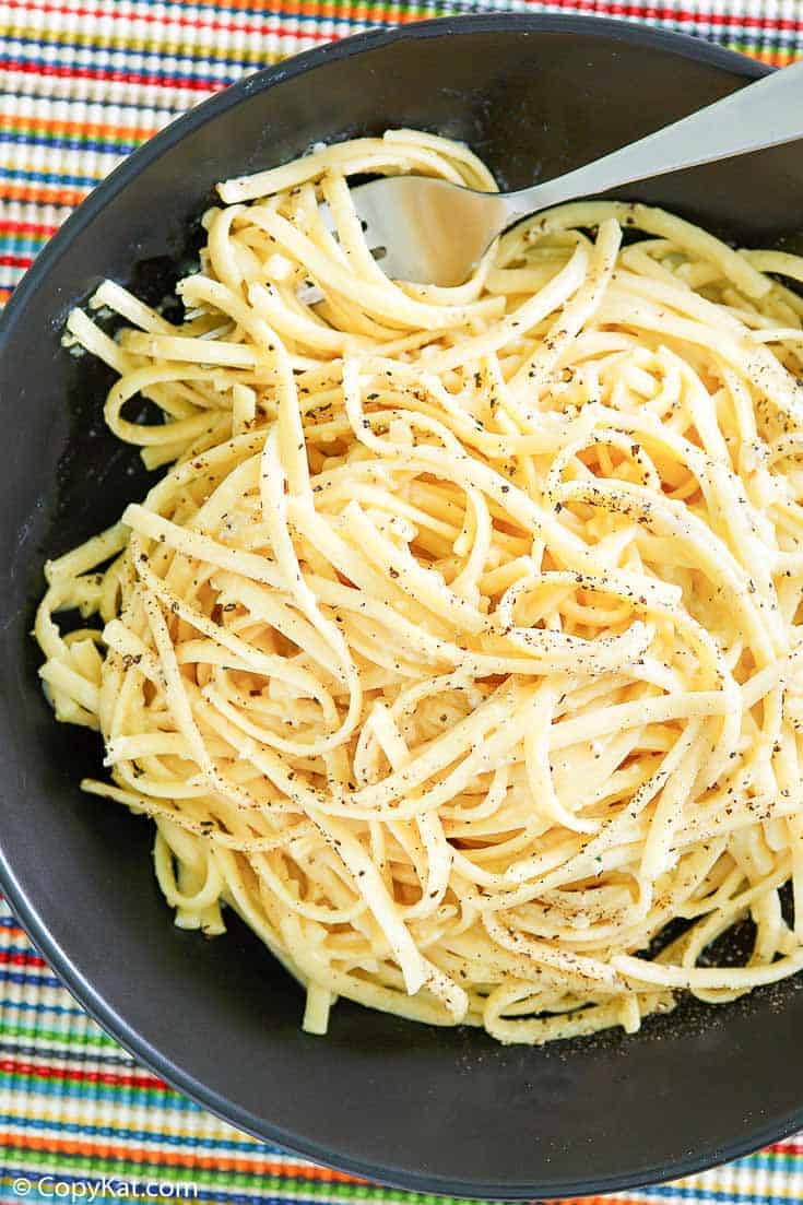 overhead view of a bowl of pasta with egg and parmesan cheese