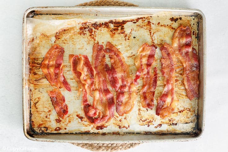 cooked bacon on a baking sheet