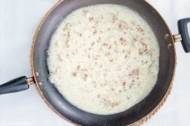 milk, bacon bits, onions, and garlic in a skillet