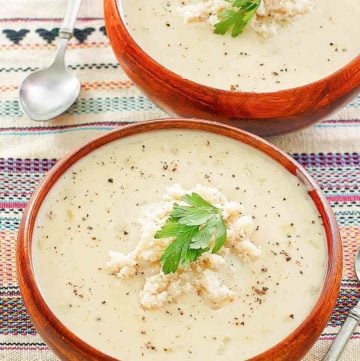 two bowls of crab bisque and two spoons