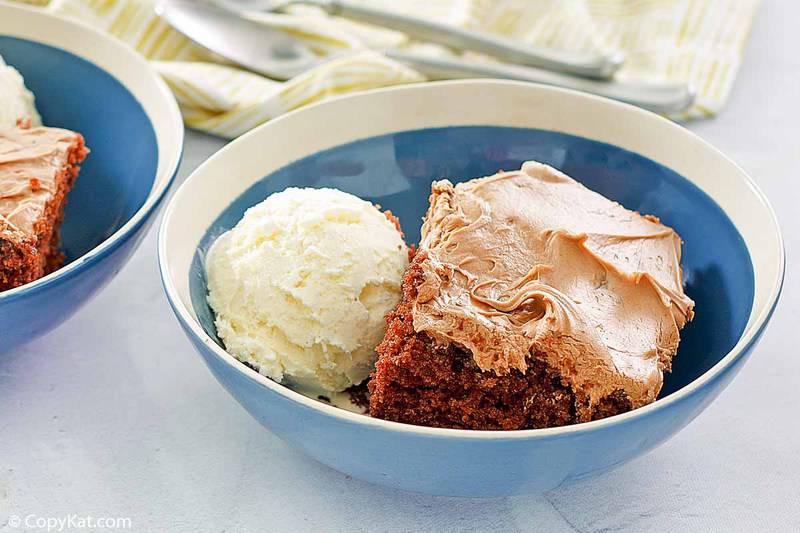 a bowl of homemade Cracker Barrel Coca Cola Cake and vanilla ice cream